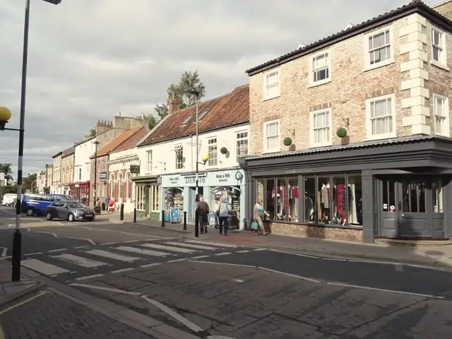 Brick shops and houses around Market Place, Pocklington, under red pantile and slate roofs